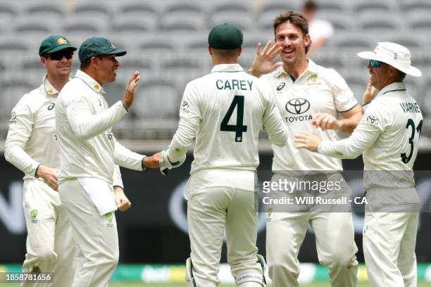 Mitch Marsh of Australia celebrates after taking the wicket of Babar Azam of Pakistan during day three of the Men's First Test match between...