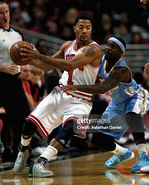 Derrick Rose of the Chicago Bulls works against Ty Lawson of the Denver Nuggets during a preseason game at the United Center on October 25, 2013 in...