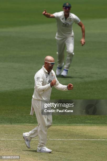 Nathan Lyon of Australia celebrates the wicket of Imam-ul-Haq of Pakistan during day three of the Men's First Test match between Australia and...