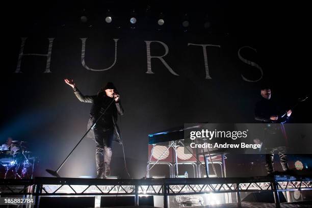 Theo Hutchcraft and Adam Anderson of Hurts perform on stage at Manchester Apollo on October 25, 2013 in Manchester, England.