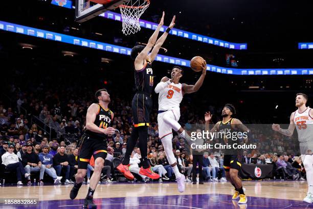 Barrett of the New York Knicks attempts a layup against Yuta Watanabe of the Phoenix Suns during the first half at Footprint Center on December 15,...