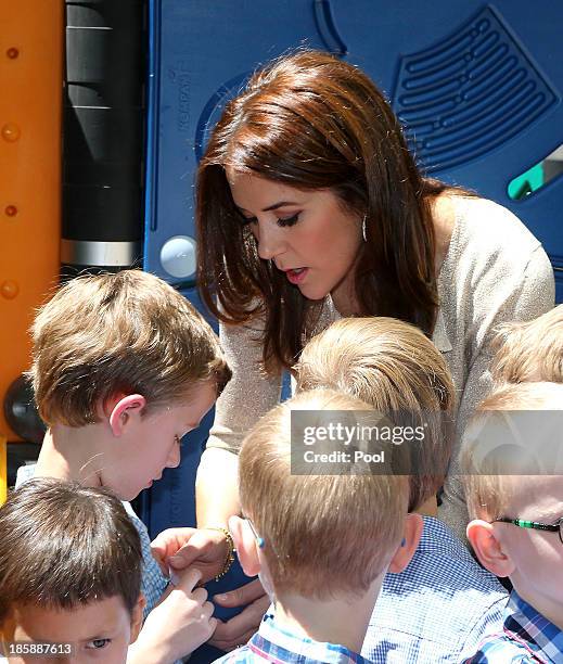 Princess Mary of Denmark interacts with children at the Children's Hospital during a visit to the Australian Twin Registry on October 26, 2013 in...