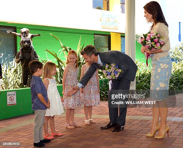 Prince Frederik and Princess Mary of Denmark are greeted by identical twins Kai and Siobhan Pereira , and Lillian and Charlotte Harding as the royal...
