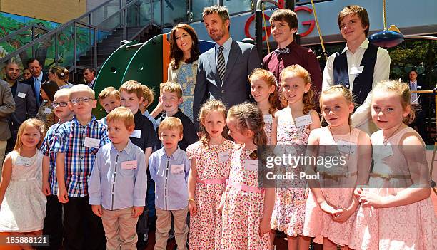 Princess Mary of Denmark and Prince Frederik of Denmark pose for a photo with identical twins during a visit to the Australian Twin Registry at the...