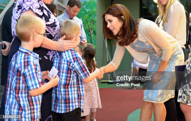 Princess Mary of Denmark meets with identical twins during a visit to the Australian Twin Registry at the Sydney Children's Hospital on October 26,...
