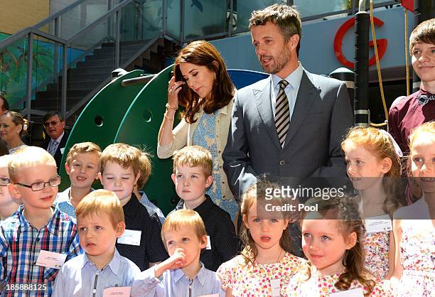 Princess Mary of Denmark and Prince Frederik of Denmark pose for a photo with identical twins during a visit to the Australian Twin Registry at the...