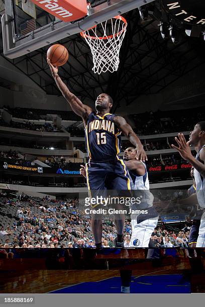 Donald Sloan of the Indiana Pacers shoots a layup against Bernard James of the Dallas Mavericks on October 25, 2013 at the American Airlines Center...