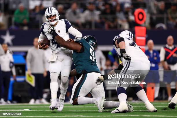 Fletcher Cox of the Philadelphia Eagles sacks Dak Prescott of the Dallas Cowboys during an NFL football game at AT&T Stadium on December 10, 2023 in...