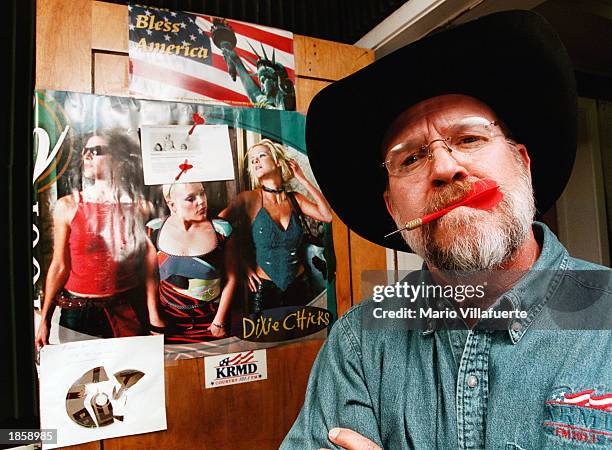 Local country radio personalities K. C. Daniels has been tossing darts at a poster of the singing trio, the Dixie Chicks, taped to the studio door at...