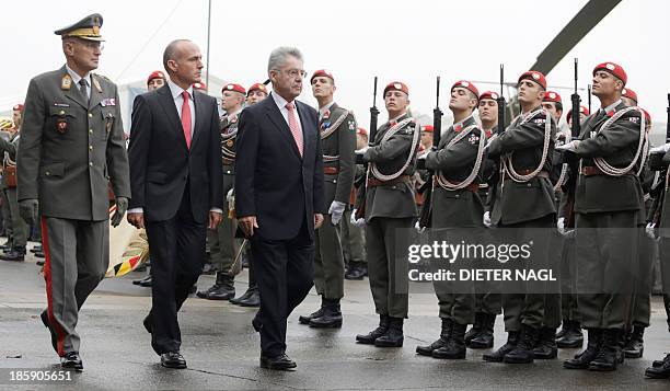 Austrian President Heinz Fischer, Austrian Defence Minister Gerhard Klug and General Othmar Commenda, Chief of the General Staff review a guard of...