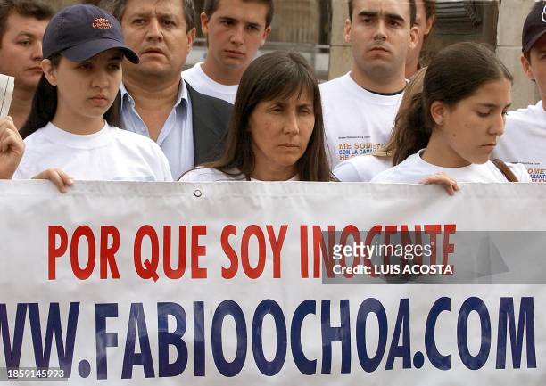 Relatives of the accused drug trafficker, Fabio Ochoa Vazquez, hold up a sign during a protest against his extradition in the Bolivar Plaza in Bogota...