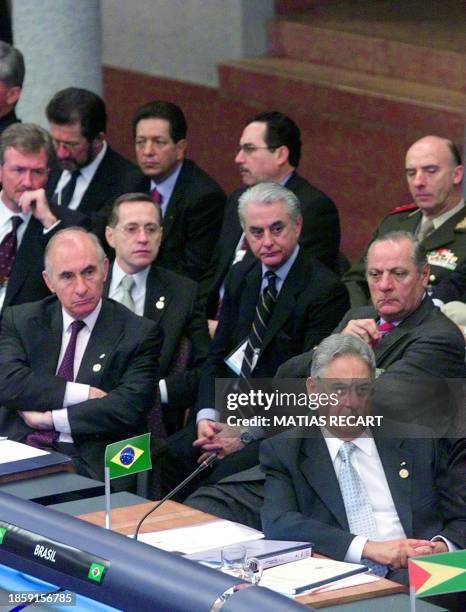 Brazilian President Fernando Henrique Cardoso and Argentinian President Fernando De La Rua listen to a speech by Colombian President Andres Pastrana...