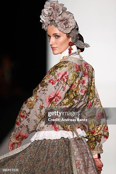 Model walks the runway at the "SLAVA ZAITSEV Pret-A-porter De Luxe" show during Mercedes-Benz Fashion Week Russia S/S 2014 on October 26, 2013 in...