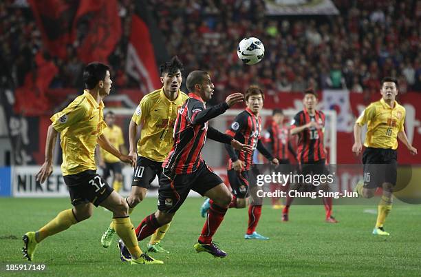 Sergio Escudero of FC Seoul competes for the ball with Sun Xiang and Zheng Zhi of Guangzhou Evergrande during the AFC Champions League Final 1st leg...