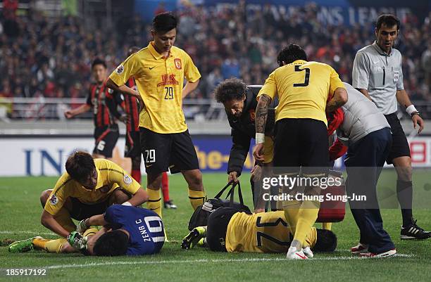 Zeng Cheng and Sun Xiang of Guangzhou Evergrande get injured during the AFC Champions League Final 1st leg match between FC Seoul and Guangzhou...
