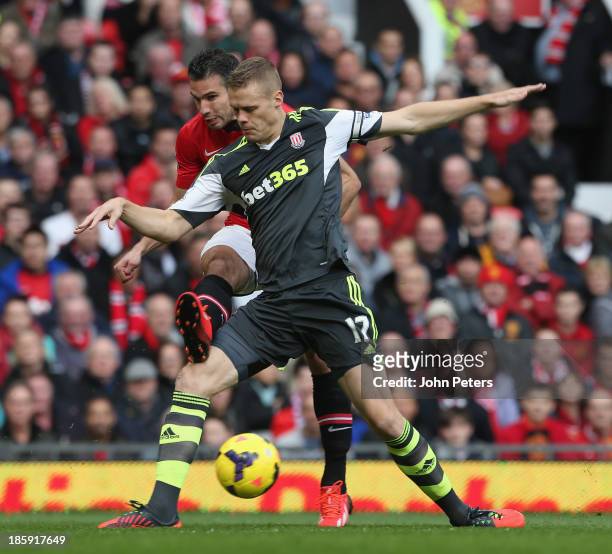 Robin van Persie of Manchester United in action with Ryan Shawcross of Stoke City during the Barclays Premier League match between Manchester United...