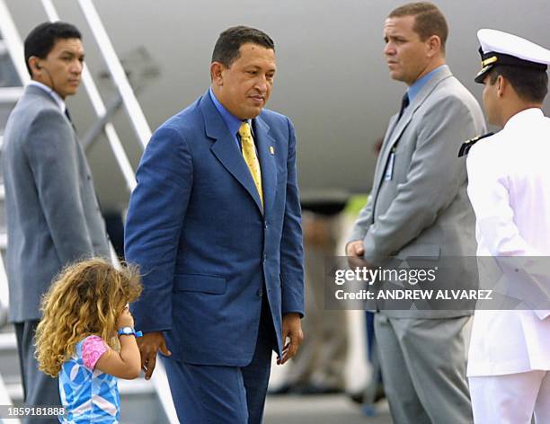 Venezuelan president Hugo Chavez Frias walks with his daughter Rosa Ines after descending from the presidential plane which returned from Peru on...