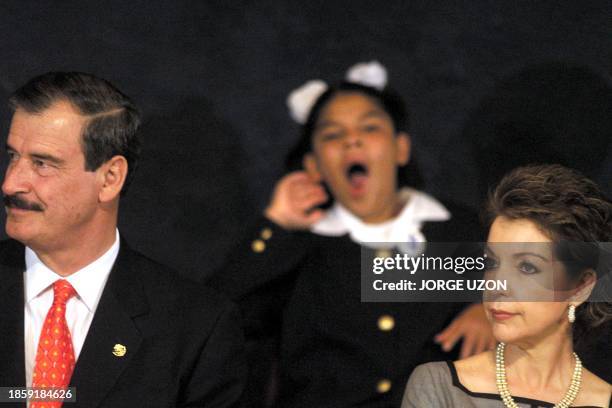 Child yawns behind Mexican President Vicente Fox and his wife, Marta Sahagun at an assembly of the National Council for Children and Adolescents 24...