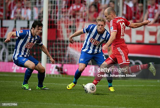 Arjen Robben of Muenchen battles for the ball with Nico Schulz and Johannes van Bergh of Berlin during the Bundesliga match between FC Bayern...