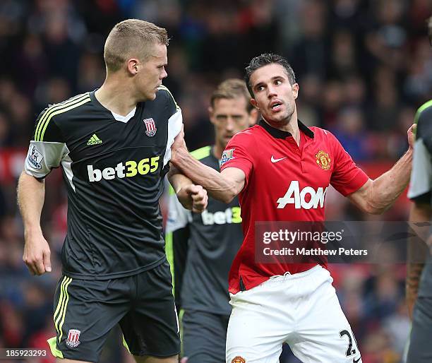 Robin van Persie of Manchester United clashes with Ryan Shawcross of Stoke City during the Barclays Premier League match between Manchester United...