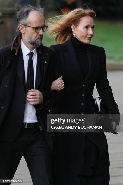 Author JK Rowling and her husband Neil Murray arrive for the funeral service of former British Chancellor of the Exchequer Alistair Darling at St...