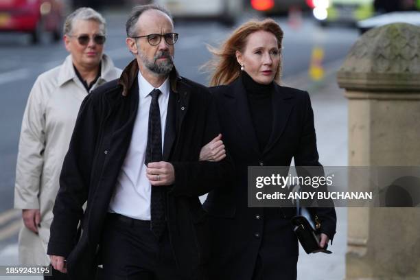 Author JK Rowling and her husband Neil Murray arrive for the funeral service of former British Chancellor of the Exchequer Alistair Darling at St...