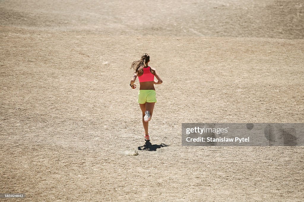 Girl running on desert