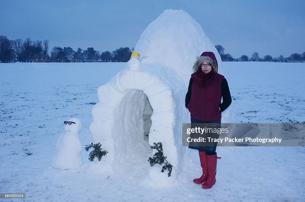 A woman stands next to an igloo in Bristol.
