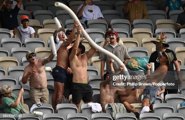 Some spectators attempt to stack cups during day three of the Men's First Test match between Australia and Pakistan at Optus Stadium on December 16,...