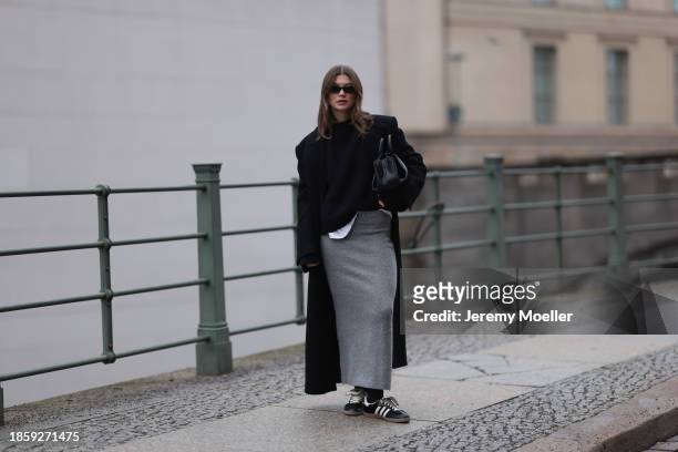 Sophia Geiss seen wearing Saint Lauren black sunglasses, silver earrings, LeGer black wool knit jumper / sweater, H&M grey wool knit long skirt, Zara...