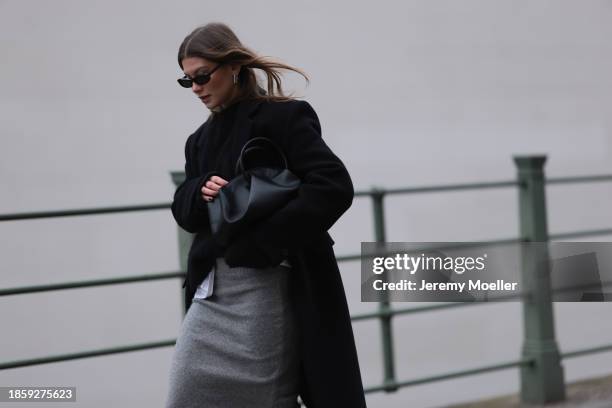 Sophia Geiss seen wearing Saint Lauren black sunglasses, silver earrings, LeGer black wool knit jumper / sweater, H&M grey wool knit long skirt, Zara...