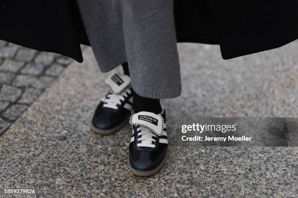 Sophia Geiss seen wearing H&M grey wool knit long skirt, Zara black oversized coat and Adidas x Wales Bonner black leather sneakers, on December 15,...