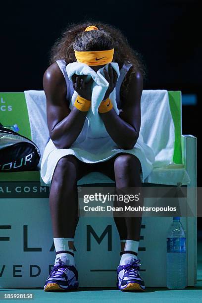 Serena Williams of the United States wipes her face on her chair between games against Jelena Jankovic of Serbia in their semi final match during day...