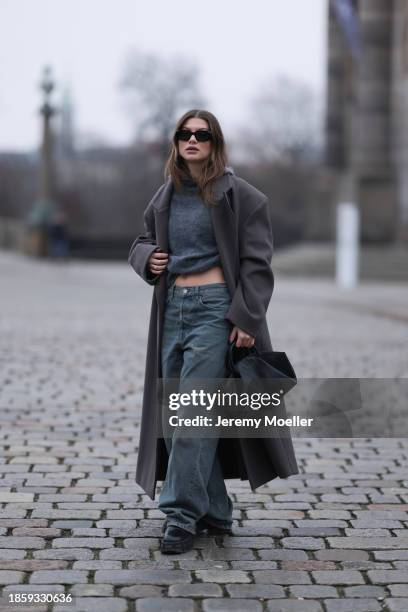 Sophia Geiss seen wearing Prada black sunglasses, silver earrings, COS grey mohair wool knit hooded pullover / sweater, COS blue washed loose wide...