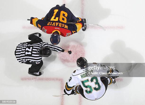Connor McDavid of the Erie Otters takes a faceoff against Bo Horvat of the London Knights during an OHL game at the Budweiser Gardens on October 25,...