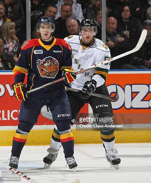 Connor McDavid of the Erie Otters is held in check by Brady Austin of the London Knights during an OHL game at the Budweiser Gardens on October 25,...