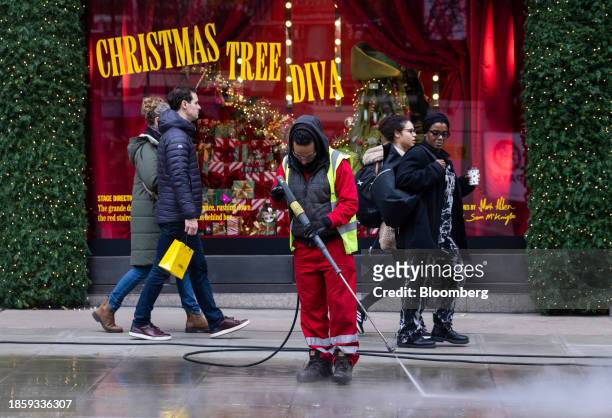 Street cleaner outside Selfridges department store on Oxford Street in London, UK, on Monday, Dec. 18, 2023. The Office for National Statistics are...