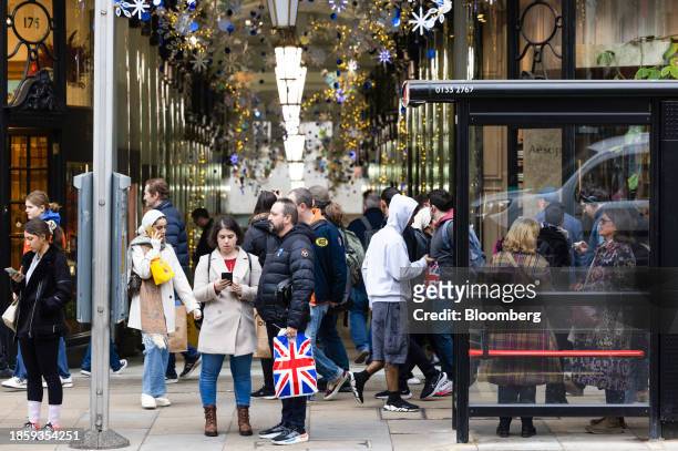 Shopper with a British Union flag branded bag on Piccadilly in London, UK, on Monday, Dec. 18, 2023. The Office for National Statistics are due to...