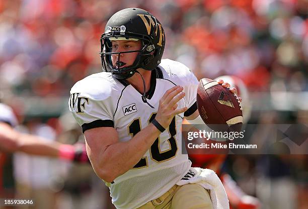 Tanner Price of the Wake Forest Demon Deacons passes during a game against the Miami Hurricanes at Sun Life Stadium on October 26, 2013 in Miami...