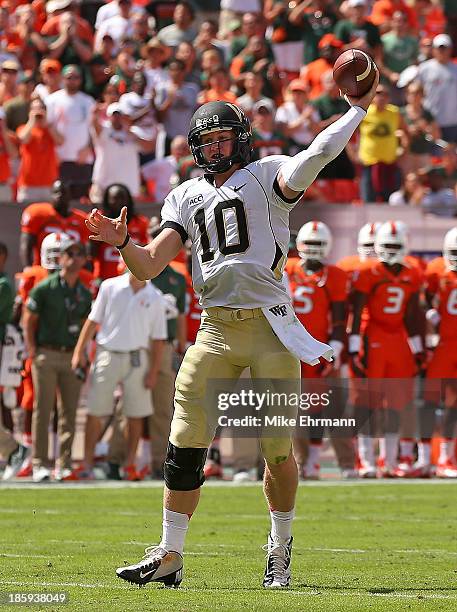 Tanner Price of the Wake Forest Demon Deacons passes during a game against the Miami Hurricanes at Sun Life Stadium on October 26, 2013 in Miami...