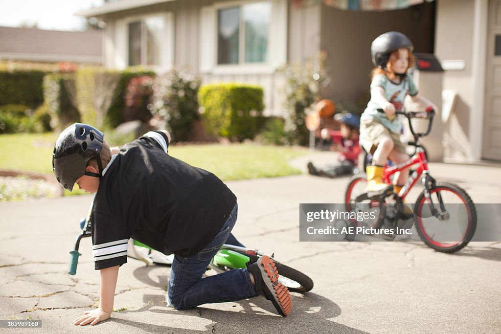 Boy falls off bike