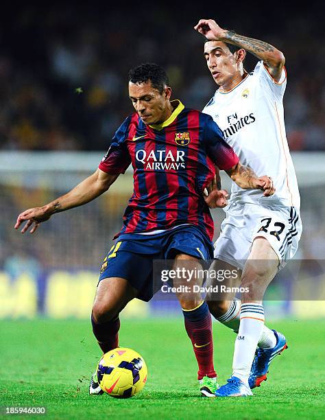 Adriano Correia of FC Barcelona duels for the ball with Angel Di Maria of Real Madrid CF during the La Liga match between FC Barcelona and Real...