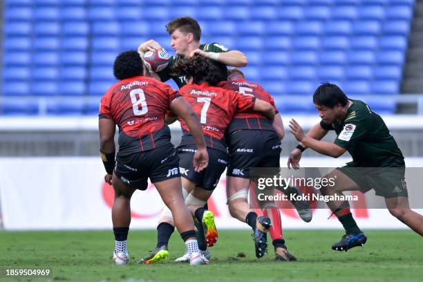 Beauden Barrett of Toyota Verblitz is tackled by Naoto Shimada and Matthew Philip of Yokohama Canon Eagles during the NTT Japan Rugby League One...