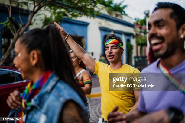 happy lgbtqia+ friends walking through the city - street party stock pictures, royalty-free photos & images