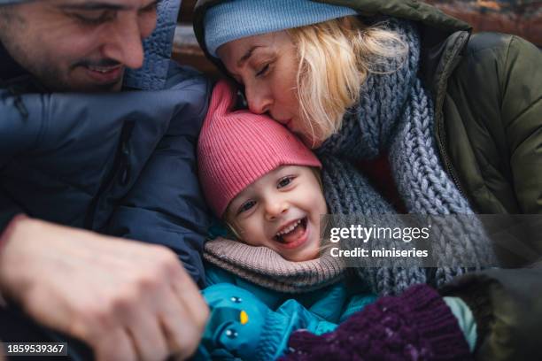 a portrait of a happy beautiful family enjoying being together during winter holidays - happy holidays family stock pictures, royalty-free photos & images
