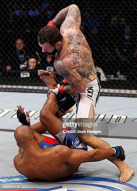 Alessio Sakara punches Nicholas Musoke in their middleweight bout during the UFC Fight Night event at Phones 4 U Arena on October 26, 2013 in...