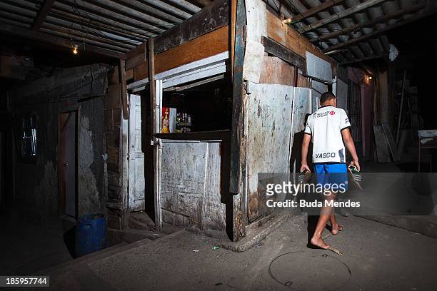 Boy returns to his home after training at the Vila Nova Project in the Morro dos Macacos area on October 26, 2013 in Rio de Janeiro, Brazil. The...