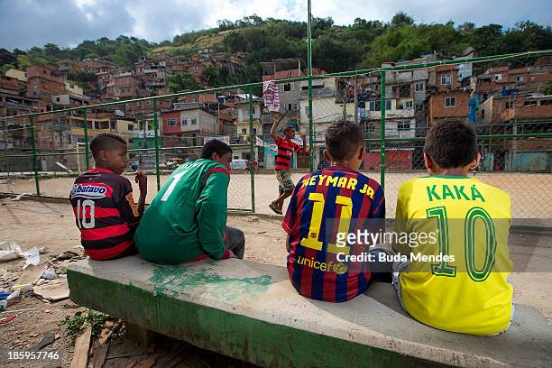 Boys watch a match at the Vila Nova Project in the Morro dos Macacos area on October 26, 2013 in Rio de Janeiro, Brazil. The Project Vila Nova was...
