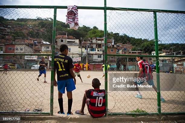 Boys watch a match at the Vila Nova Project in the Morro dos Macacos area on October 26, 2013 in Rio de Janeiro, Brazil. The Project Vila Nova was...