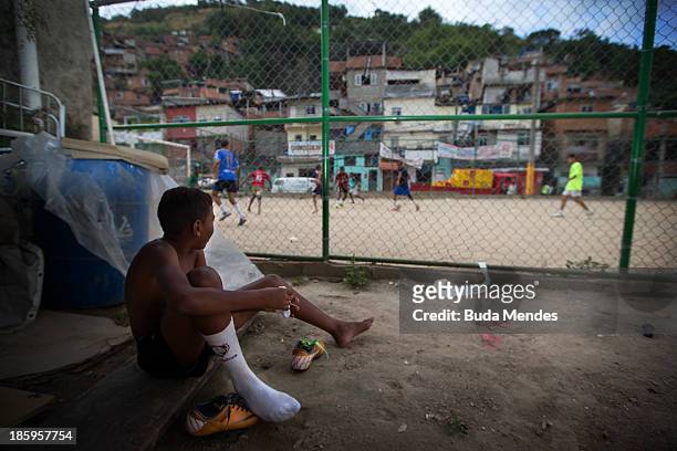 Boy watches a match at the Vila Nova Project in the Morro dos Macacos area on October 26, 2013 in Rio de Janeiro, Brazil. The Project Vila Nova was...